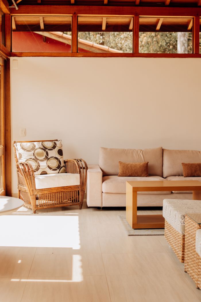 services-03 Bright living room featuring wicker furniture and soft sofas in São Paulo.