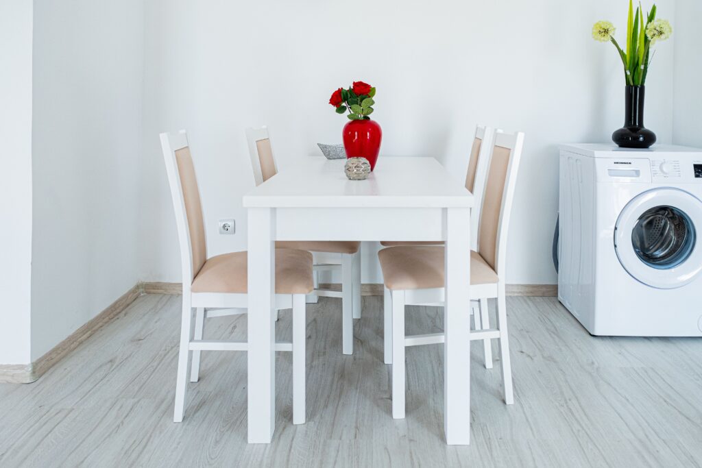 pexels-photo-17918541-17918541 A stylish minimalist dining area with white furniture and red roses.