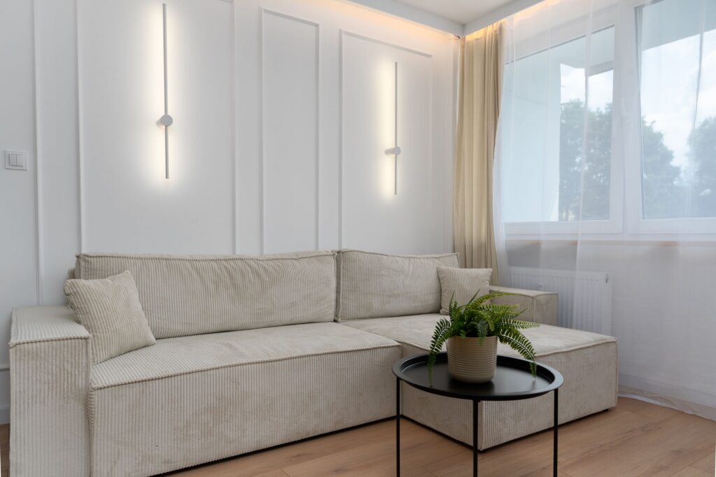pexels-photo-33054910-33054910 Elegant minimalist living room featuring a beige sofa and modern lighting, Kraków.